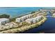 An aerial view of waterfront condos with a water view and well-maintained landscaping and community areas at 384 Aruba Cir # 103, Bradenton, FL 34209