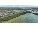 Picturesque aerial view of waterfront condos surrounded by lush greenery and serene waters at 384 Aruba Cir # 103, Bradenton, FL 34209