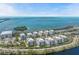 Stunning aerial perspective of condos with ocean views, nearby waters, and surrounding coastal neighborhood at 384 Aruba Cir # 103, Bradenton, FL 34209