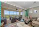 Expansive balcony featuring comfortable seating and panoramic water views, seamlessly connected to the indoor living space at 384 Aruba Cir # 103, Bradenton, FL 34209