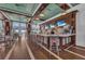 Modern bar area featuring barstool seating, multiple TVs, pendant lighting, and ocean views through expansive windows at 384 Aruba Cir # 103, Bradenton, FL 34209