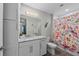 Bathroom featuring a granite-topped vanity and a shower with a colorful curtain at 384 Aruba Cir # 103, Bradenton, FL 34209