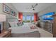 Bright bedroom boasts coastal views, colorful accents, and a ceiling fan at 384 Aruba Cir # 103, Bradenton, FL 34209