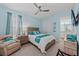 Bright bedroom with a queen bed, ceiling fan, and coastal-themed decorations at 384 Aruba Cir # 103, Bradenton, FL 34209