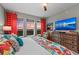 Bright bedroom boasts coastal views, colorful accents, and a ceiling fan at 384 Aruba Cir # 103, Bradenton, FL 34209