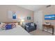 Bedroom featuring a bed, seating area, and a wall-mounted television at 384 Aruba Cir # 103, Bradenton, FL 34209