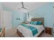 Bedroom featuring a queen bed with coastal decor and a ceiling fan at 384 Aruba Cir # 103, Bradenton, FL 34209