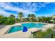 Beautiful community pool area with ample seating, lush landscaping, and a serene atmosphere at 384 Aruba Cir # 103, Bradenton, FL 34209