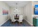 Charming dining room with seating for six, featuring a decorative mirror and a colorful accent rug at 384 Aruba Cir # 103, Bradenton, FL 34209