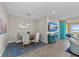 Elegant dining area with a modern chandelier, stylish decor, and a comfortable seating arrangement for six at 384 Aruba Cir # 103, Bradenton, FL 34209