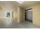 Well-lit hallway leading to the units with an elevator for easy access at 384 Aruba Cir # 103, Bradenton, FL 34209