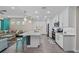 Modern kitchen with stainless steel appliances, a granite-topped island, and an open flow to the living area at 384 Aruba Cir # 103, Bradenton, FL 34209