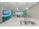 Bright, open kitchen with granite countertops, scenic water views, and modern appliances at 384 Aruba Cir # 103, Bradenton, FL 34209