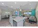 Bright, open-concept living space with island kitchen, dining area, and comfortable seating overlooking scenic views at 384 Aruba Cir # 103, Bradenton, FL 34209