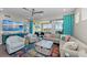 Cozy living area with comfortable seating, a balcony offering water views, and vibrant, colorful accents throughout at 384 Aruba Cir # 103, Bradenton, FL 34209