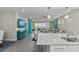 Spacious living area featuring modern decor, island seating, and a large sliding glass door leading to outdoor views at 384 Aruba Cir # 103, Bradenton, FL 34209