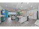 Open-concept living space with kitchen island, coastal decor, and water views at 384 Aruba Cir # 103, Bradenton, FL 34209