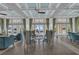 Bright lobby with coffered ceilings, striped chairs, and floor-to-ceiling windows offering water views at 384 Aruba Cir # 103, Bradenton, FL 34209