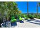 Relaxing lounge chairs on a sun-drenched patio, surrounded by tropical foliage and palm trees at 384 Aruba Cir # 103, Bradenton, FL 34209