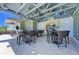 Well-appointed outdoor kitchen and dining area with modern appliances and comfortable seating for entertaining at 384 Aruba Cir # 103, Bradenton, FL 34209