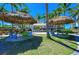Relaxing outdoor seating area with tiki umbrellas and colorful chairs, perfect for enjoying the beautiful tropical surroundings at 384 Aruba Cir # 103, Bradenton, FL 34209