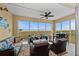 Relax on the screened patio with comfortable seating and a ceiling fan, offering stunning water views at 384 Aruba Cir # 103, Bradenton, FL 34209