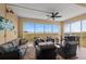 Relax on the screened patio with comfortable seating and a ceiling fan, offering stunning water views at 384 Aruba Cir # 103, Bradenton, FL 34209