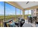 Relax on the screened patio with comfortable seating and a ceiling fan, offering stunning water views at 384 Aruba Cir # 103, Bradenton, FL 34209