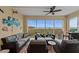 Relax on the screened patio with comfortable seating and a ceiling fan, offering stunning water views at 384 Aruba Cir # 103, Bradenton, FL 34209