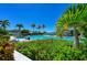 Relaxing pool area with lush landscaping and bay views at 384 Aruba Cir # 103, Bradenton, FL 34209