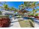 Walkway with a gazebo and shade structures, furnished with colorful seating areas, landscaping, and nearby buildings at 384 Aruba Cir # 103, Bradenton, FL 34209