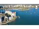 Gorgeous aerial view of a waterfront condo featuring lush tropical landscaping and private dock at 400 Golden Gate Pt # 51 & 52, Sarasota, FL 34236
