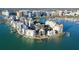 Aerial view of waterfront condos on bay, showcasing docks, city skyline, and water views at 400 Golden Gate Pt # 51 & 52, Sarasota, FL 34236