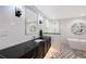 Modern bathroom featuring a stylish vanity with a dark countertop and a sleek, glass-enclosed shower at 400 Golden Gate Pt # 51 & 52, Sarasota, FL 34236