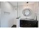 Modern bathroom with a glass shower, geometric floor, and vanity with a mirrored accent at 400 Golden Gate Pt # 51 & 52, Sarasota, FL 34236
