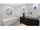 Bright bathroom featuring a modern tub, geometric tile floor, and vanity with a mirrored accent at 400 Golden Gate Pt # 51 & 52, Sarasota, FL 34236