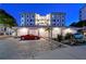 A luxurious building featuring covered parking, lush landscaping, and elegant design at 400 Golden Gate Pt # 51 & 52, Sarasota, FL 34236