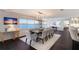 An open concept living space boasts dining and kitchen areas with exquisite features and views at 400 Golden Gate Pt # 51 & 52, Sarasota, FL 34236
