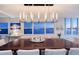 Elegant dining room featuring a contemporary chandelier and scenic water view windows at 400 Golden Gate Pt # 51 & 52, Sarasota, FL 34236