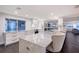 Modern kitchen with a large marble island, stainless steel appliances, and ample storage at 400 Golden Gate Pt # 51 & 52, Sarasota, FL 34236