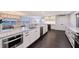 Elegant kitchen with stainless appliances, granite counters, and access to dining and living spaces at 400 Golden Gate Pt # 51 & 52, Sarasota, FL 34236