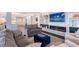 Cozy living room featuring a fireplace, built-in shelving, and comfortable seating at 400 Golden Gate Pt # 51 & 52, Sarasota, FL 34236