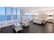 Serene main bedroom with built-in storage and expansive waterfront views from large windows at 400 Golden Gate Pt # 51 & 52, Sarasota, FL 34236