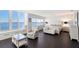 Bright main bedroom with waterfront views, sitting area, and a calming, neutral palette at 400 Golden Gate Pt # 51 & 52, Sarasota, FL 34236
