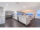 Open concept living area with a kitchen island, dining area, and comfortable seating with a water view at 400 Golden Gate Pt # 51 & 52, Sarasota, FL 34236