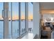 Expansive water view from a large window, showcasing a bridge and the setting sun at 400 Golden Gate Pt # 51 & 52, Sarasota, FL 34236