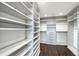 Organized walk-in closet with custom shelving and ample storage space at 400 Golden Gate Pt # 51 & 52, Sarasota, FL 34236