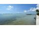 Serene waterfront view featuring a bridge and calm turquoise waters meeting the shoreline at 400 Golden Gate Pt # 51 & 52, Sarasota, FL 34236