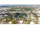 Bird's-eye view features a vibrant residential area with lush greenery and diverse housing styles at 411 S Oxford Dr # 411, Nokomis, FL 34275