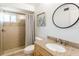 Bright bathroom features granite countertops, tile-surround shower and modern fixtures at 411 S Oxford Dr # 411, Nokomis, FL 34275